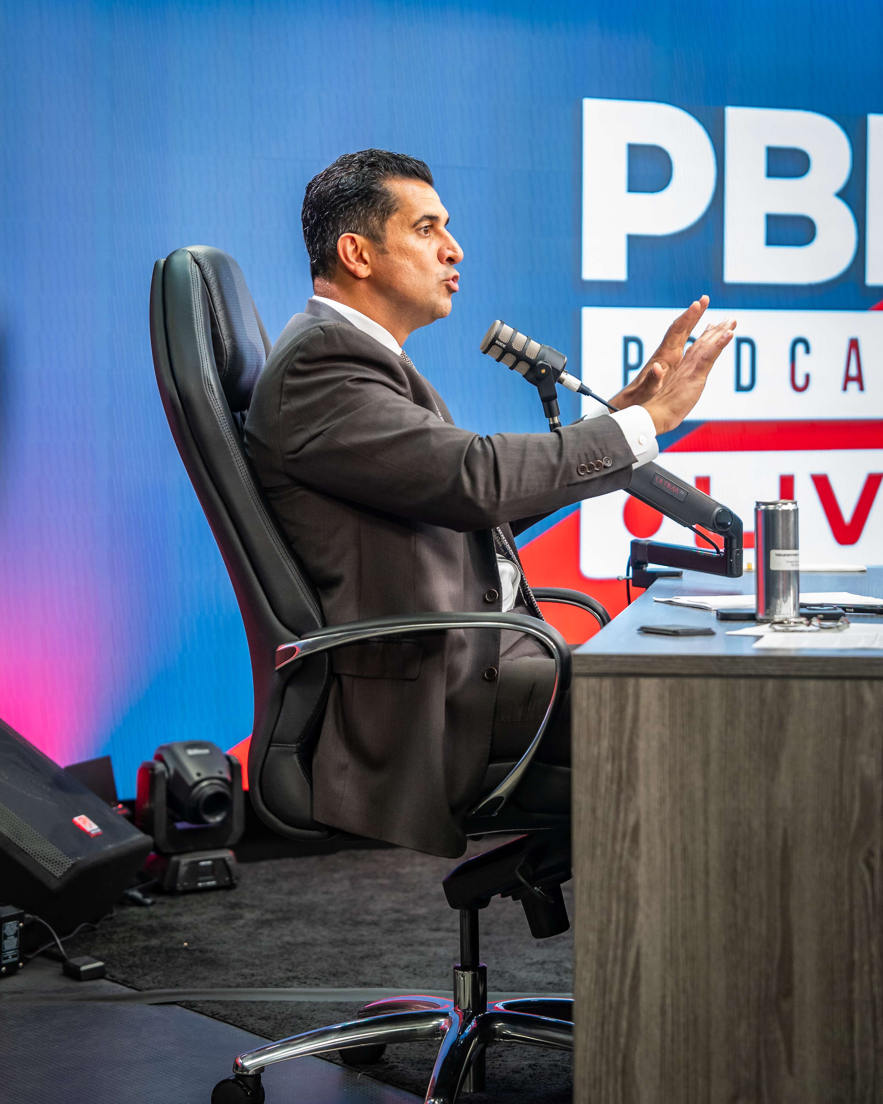 Patrick Bet-David speaking — side profile at podcast desk