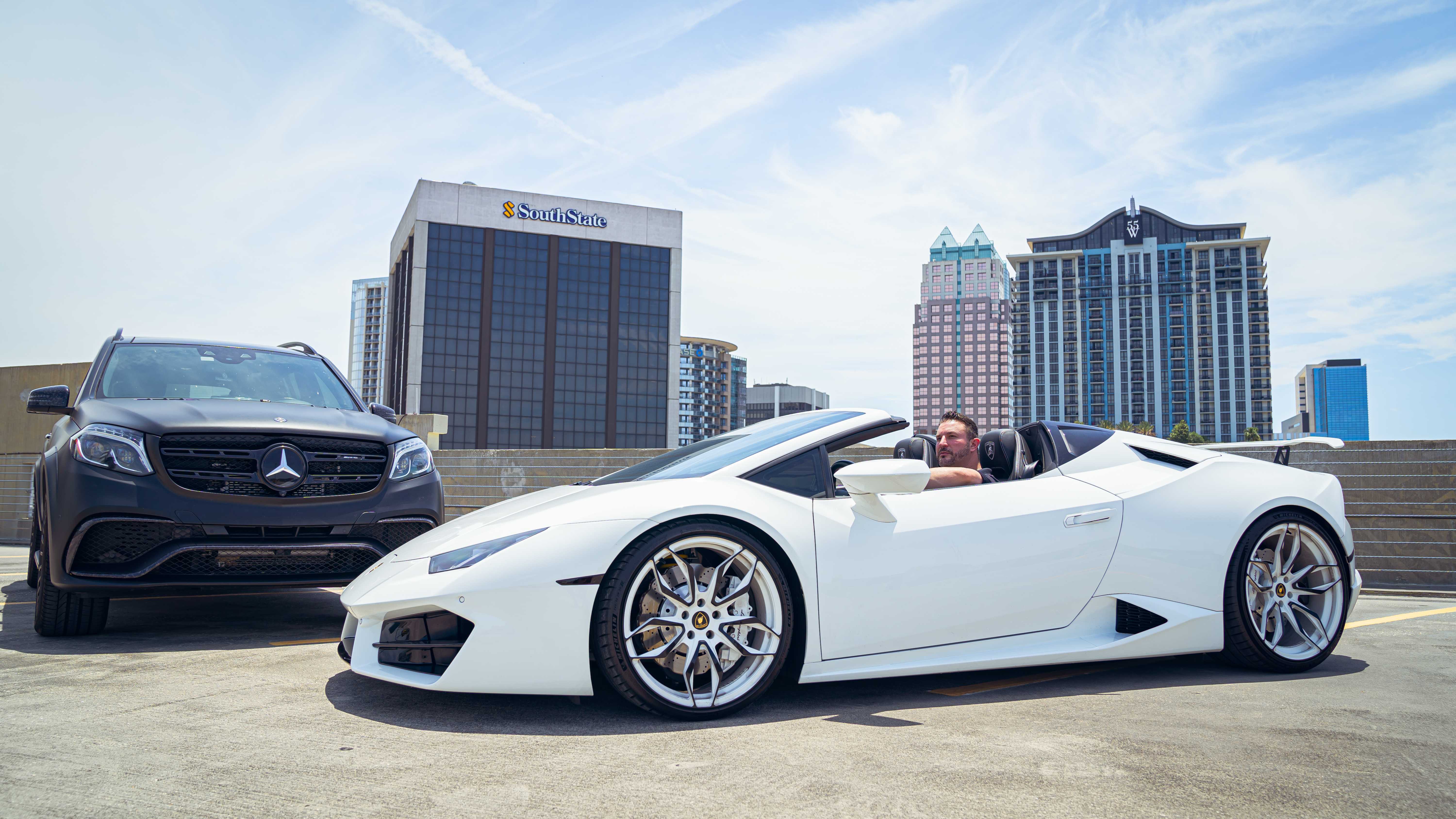 Luxury vehicles on rooftop — Lamborghini and Mercedes